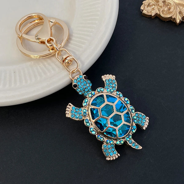 Llavero de tortuga en metal dorado esmaltado con cristales