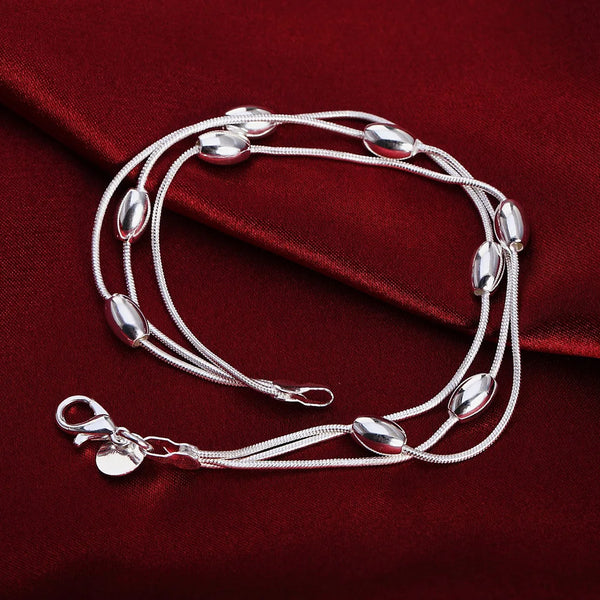 Pulsera de cuentas con borlas en acero inoxidable y baño de plata